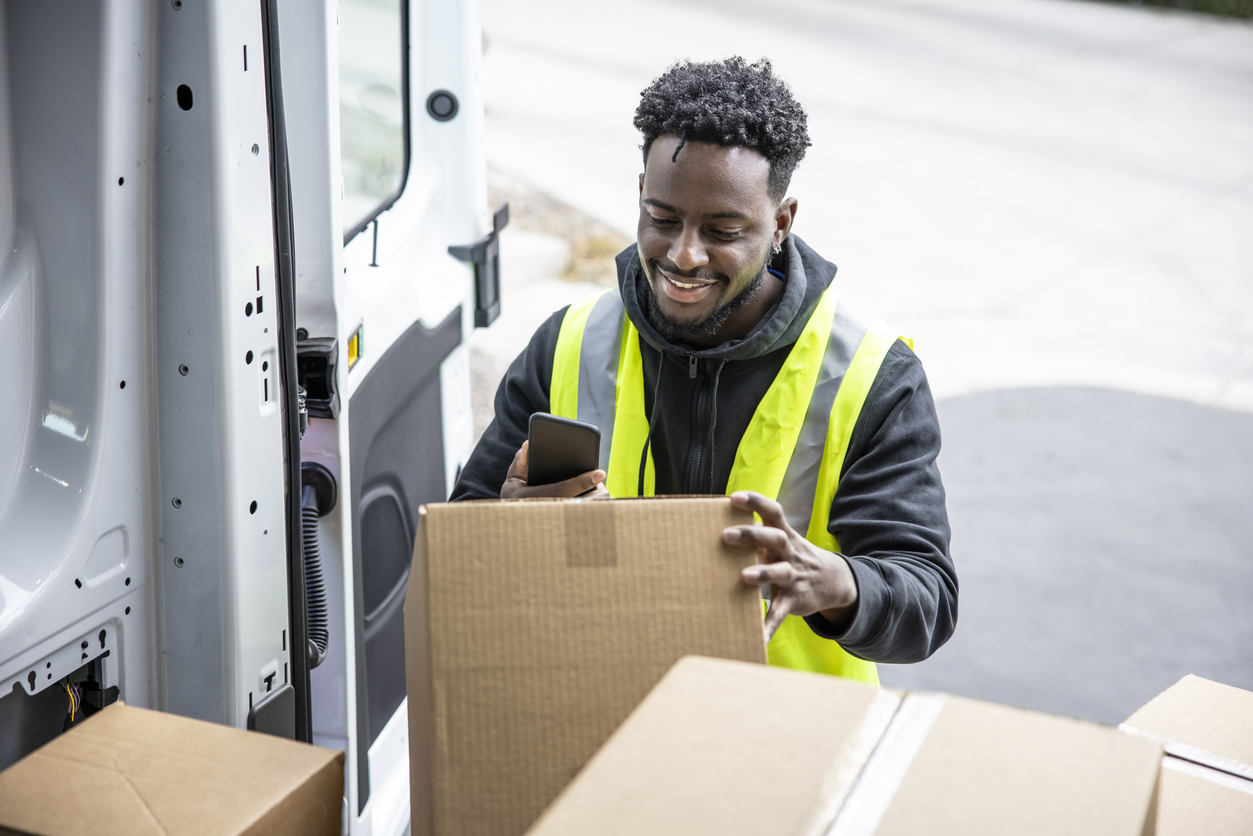 An African American man making deliveries from his cargo van